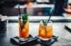 two brown liquid inside clear drinking glasses