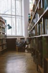 woman reading in library