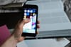 crop unrecognizable person choosing application on smartphone
