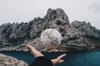 person tossing globe