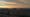 picturesque cityscape under cloudy sky on sundown