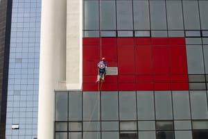 photo of man cleaning the building during daytime