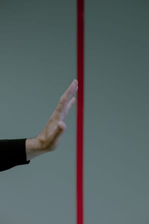 unrecognizable hand approaching red line